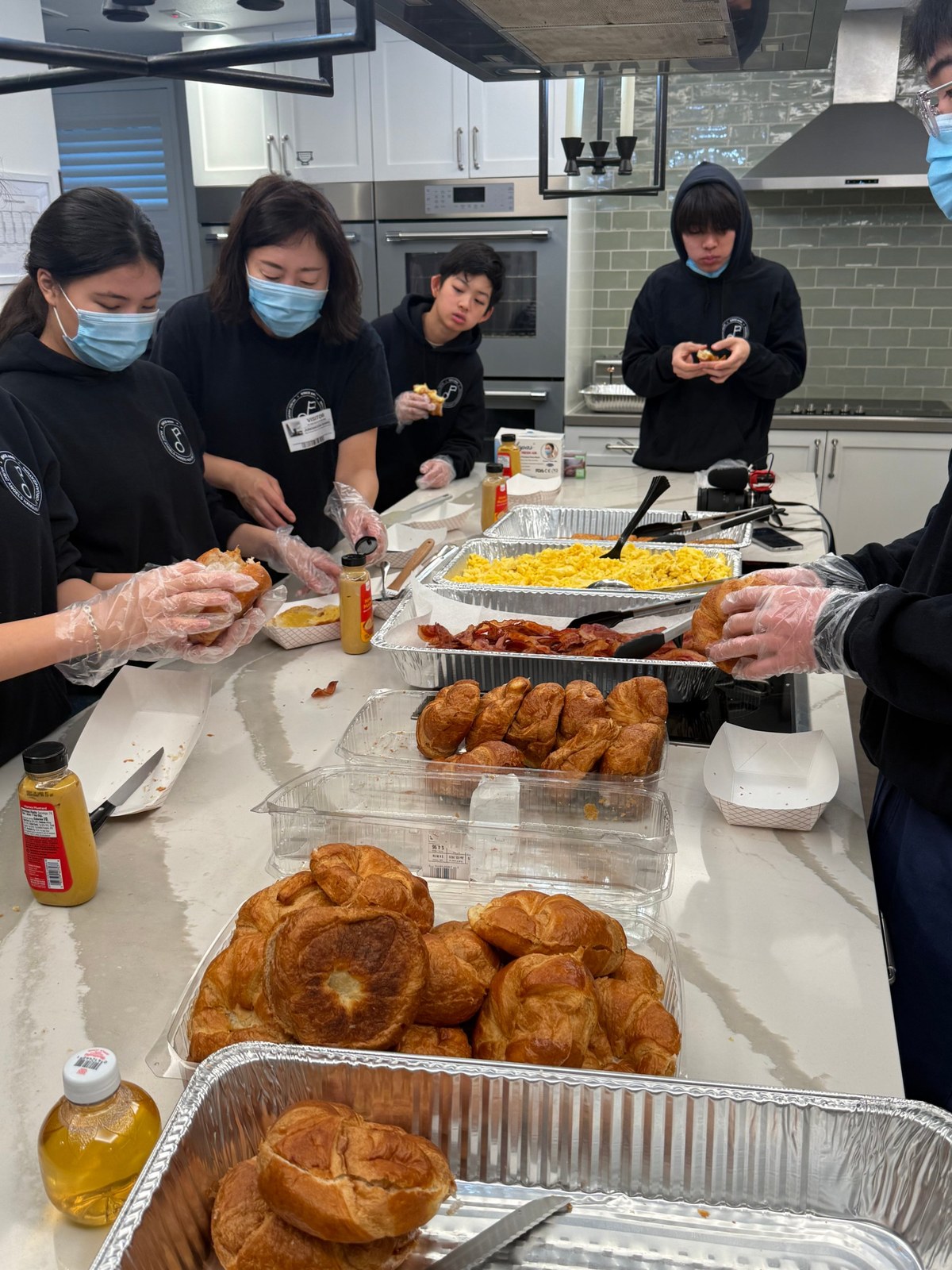 Music Angels Hands students preparing and serving food in a kitchen